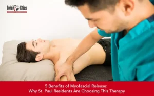 Chiropractor performing myofascial release therapy on a patient’s shoulder and upper body to relieve muscle tension and pain.