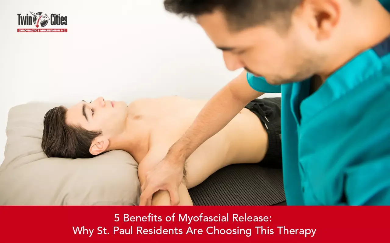 Chiropractor performing myofascial release therapy on a patient’s shoulder and upper body to relieve muscle tension and pain.