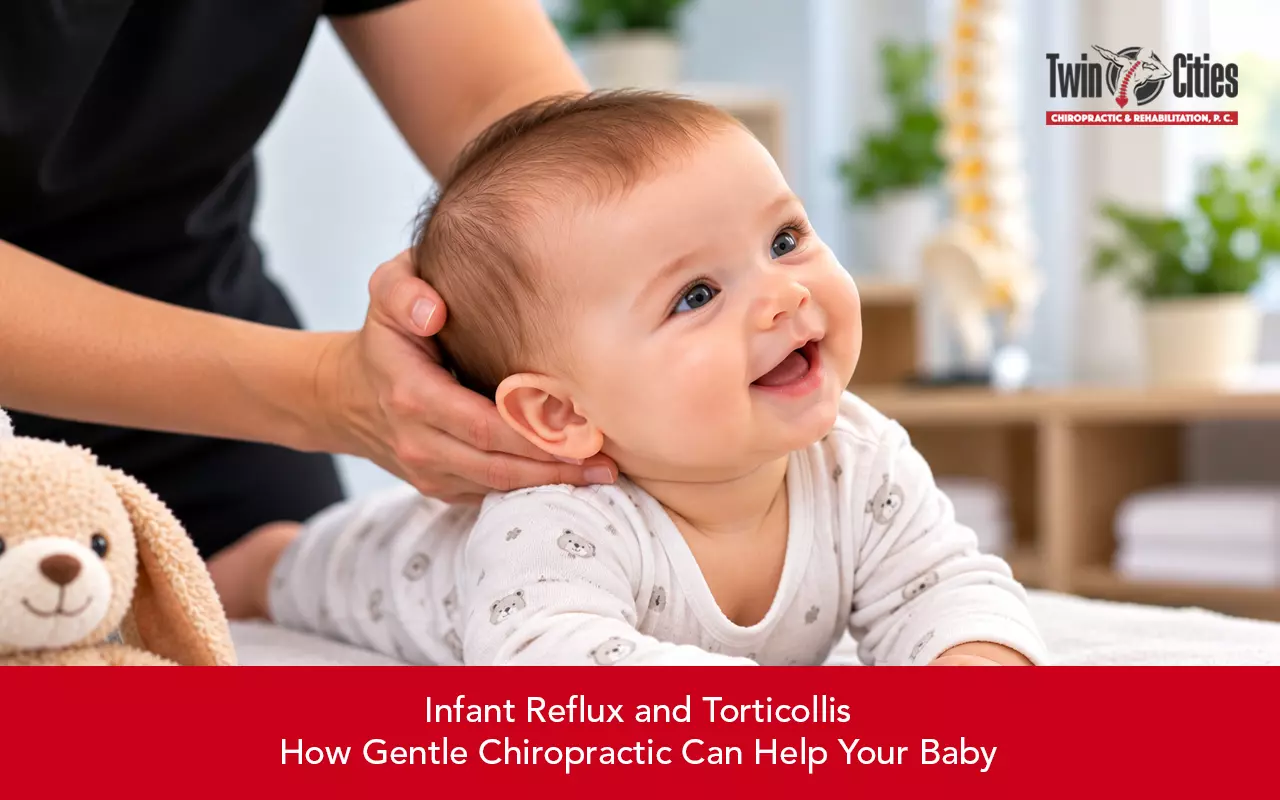 Smiling baby receiving gentle chiropractic support for infant reflux and torticollis.